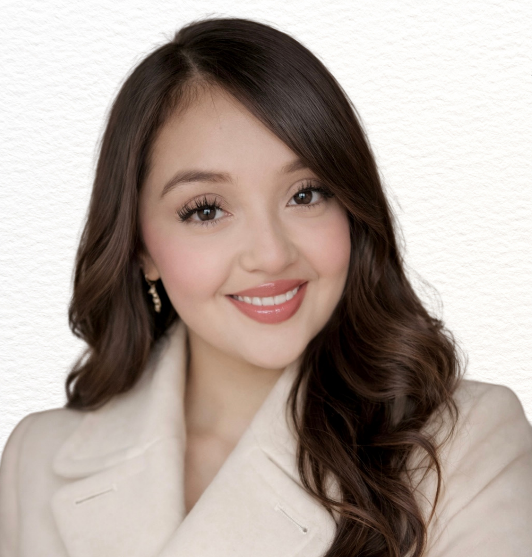 Haidy Rivera smiling in a cream blazer